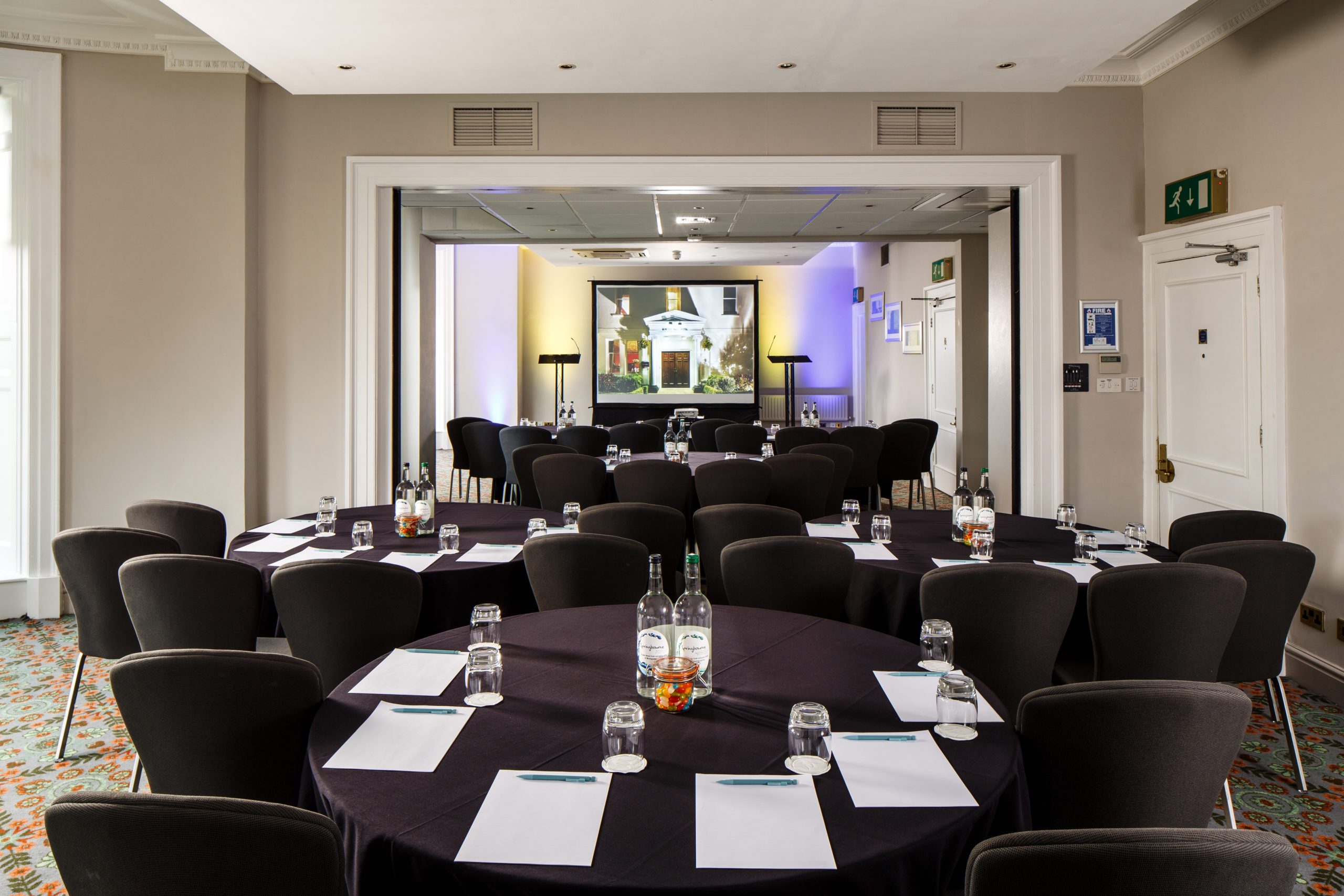 Tables and chairs set for a meeting or conference in The Ambassador Room at mercure gloucester bowden hall hotel