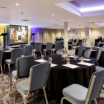 Angled view of The Lakeside Suite at mercure gloucester bowden hall hotel ready for a conference and presentation on the large video screen