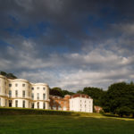 Wide shot from the left of the grounds and frontage of the mercure gloucester bowden hall hotel in daylight