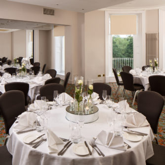 Tables with place settings for a luncheon in The Ambassador Suite at mercure gloucester bowden hall hotel