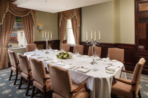 Long dining table set for lunch or dinner in The Boardroom at mercure gloucester bowden hall hotel