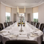 Large dining table in The Congress Room at mercure gloucester bowden hall hotel with place settings for lunch or dinner for 18 people