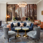 Straight on view of the lounge area with sofas chairs and artwork at mercure gloucester bowden hall hotel