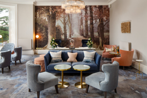 Straight on view of the lounge area with sofas chairs and artwork at mercure gloucester bowden hall hotel