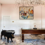 Angled view of the painting and wire wall sculpture in the reception area at mercure gloucester bowden hall hotel