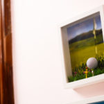 Close up of golfing artwork in reception area of Mercure Gloucester Bowden Hall Hotel