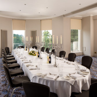 Large dining table in The Congress Room at mercure gloucester bowden hall hotel with place settings for lunch or dinner for 18 people