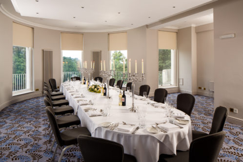 Large dining table in The Congress Room at mercure gloucester bowden hall hotel with place settings for lunch or dinner for 18 people