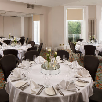 Tables with place settings for a luncheon in The Presidential Suite at mercure gloucester bowden hall hotel